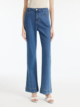 A lady wears denim rose-printed jeans.